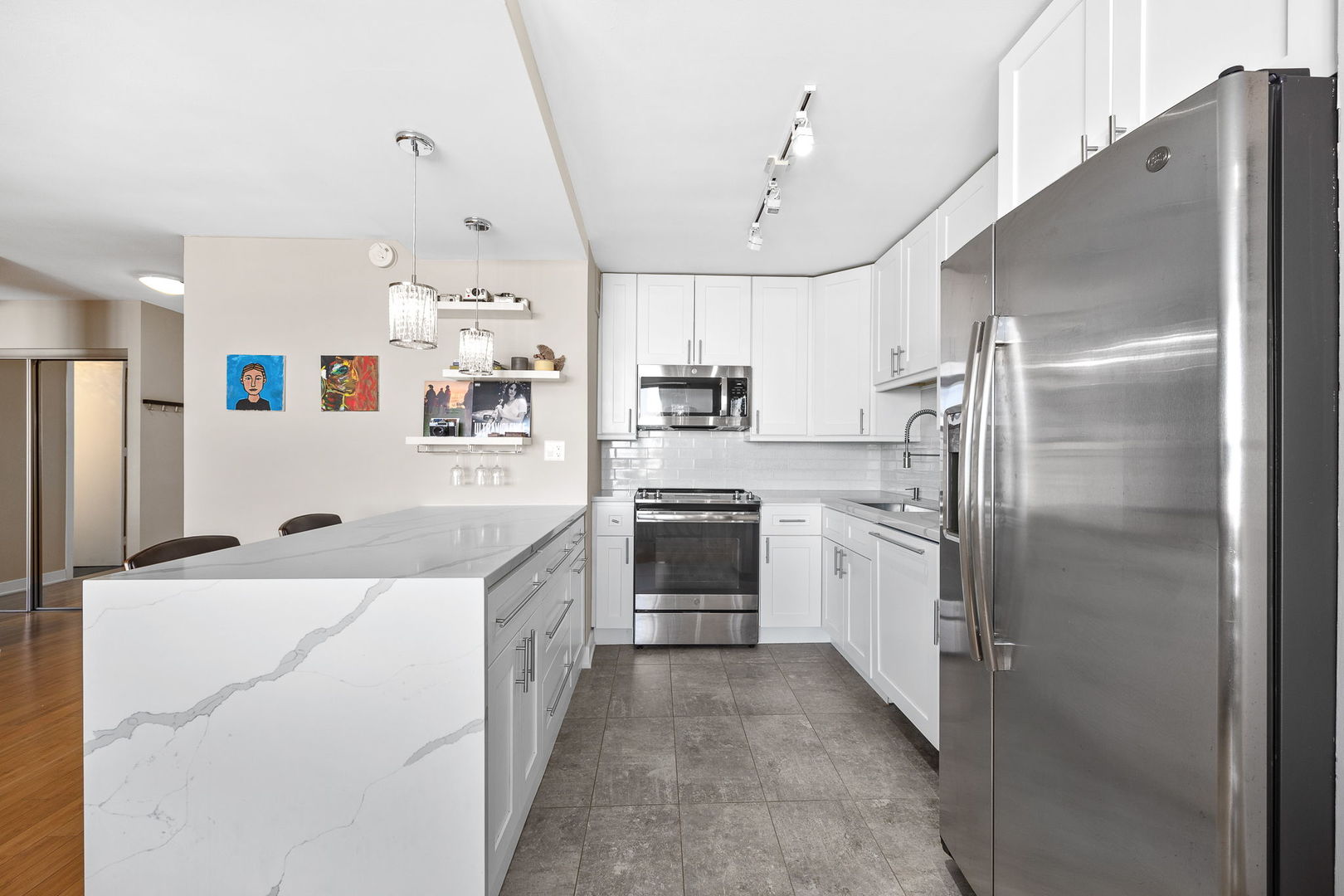 655 West Irving Park Road, Unit 3708 Chicago, IL 60613 - Photo 30 of 55 a kitchen with stainless steel appliances a refrigerator sink and white cabinets