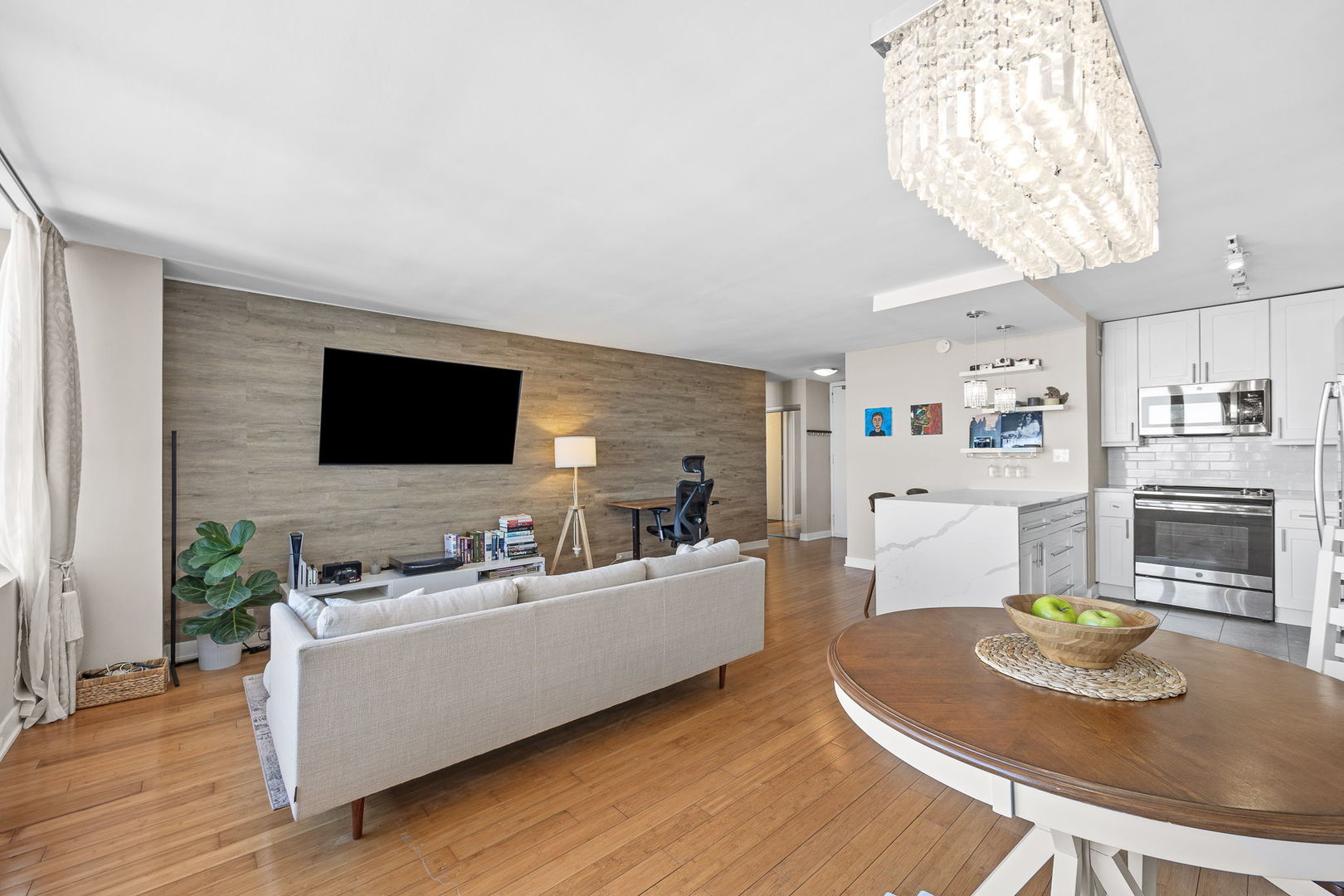 655 West Irving Park Road, Unit 3708 Chicago, IL 60613 - Photo 32 of 55 a living room with furniture and a flat screen tv