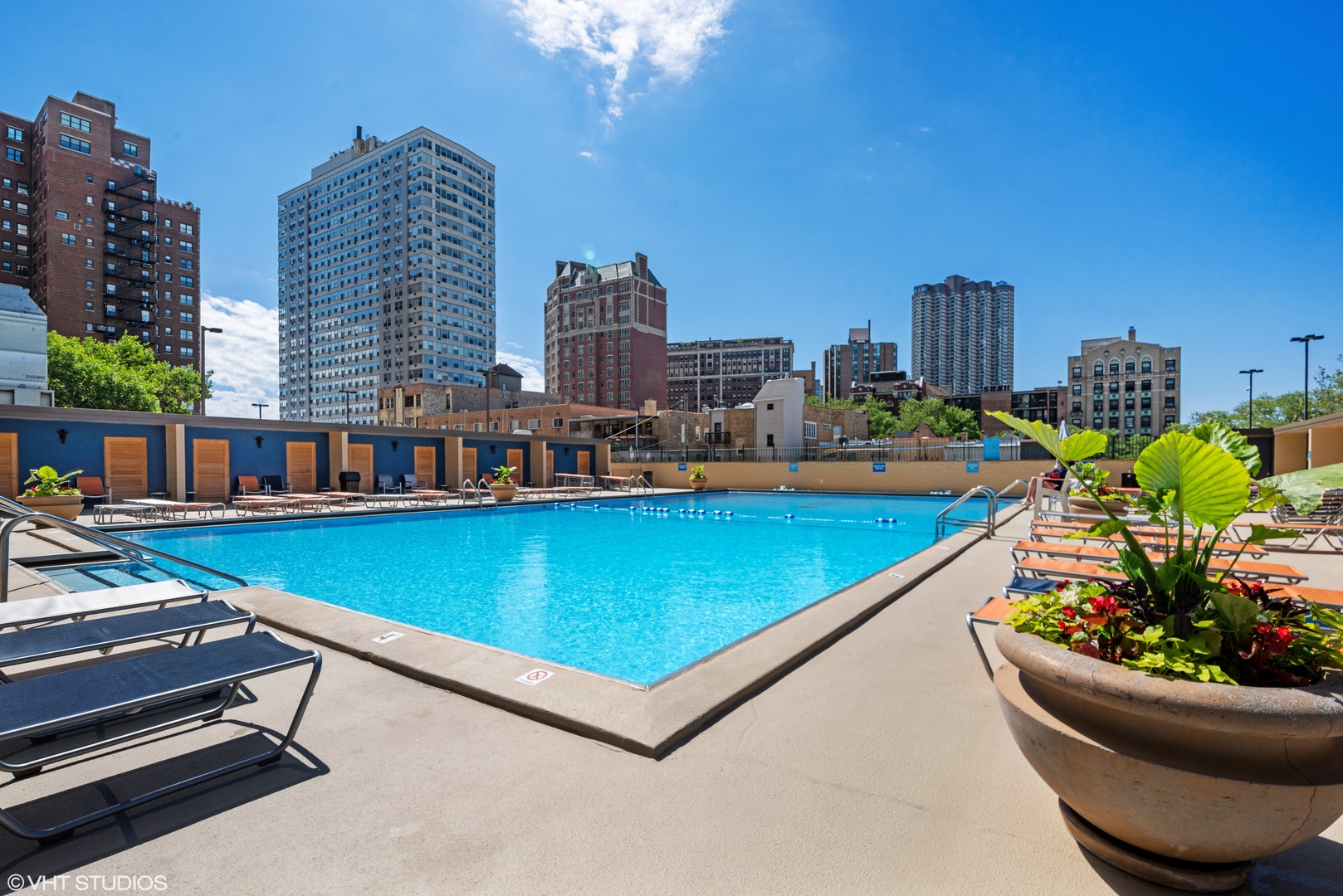 655 West Irving Park Road, Unit 3708 Chicago, IL 60613 - Photo 37 of 55 a view of a swimming pool with outdoor seating and a buildings