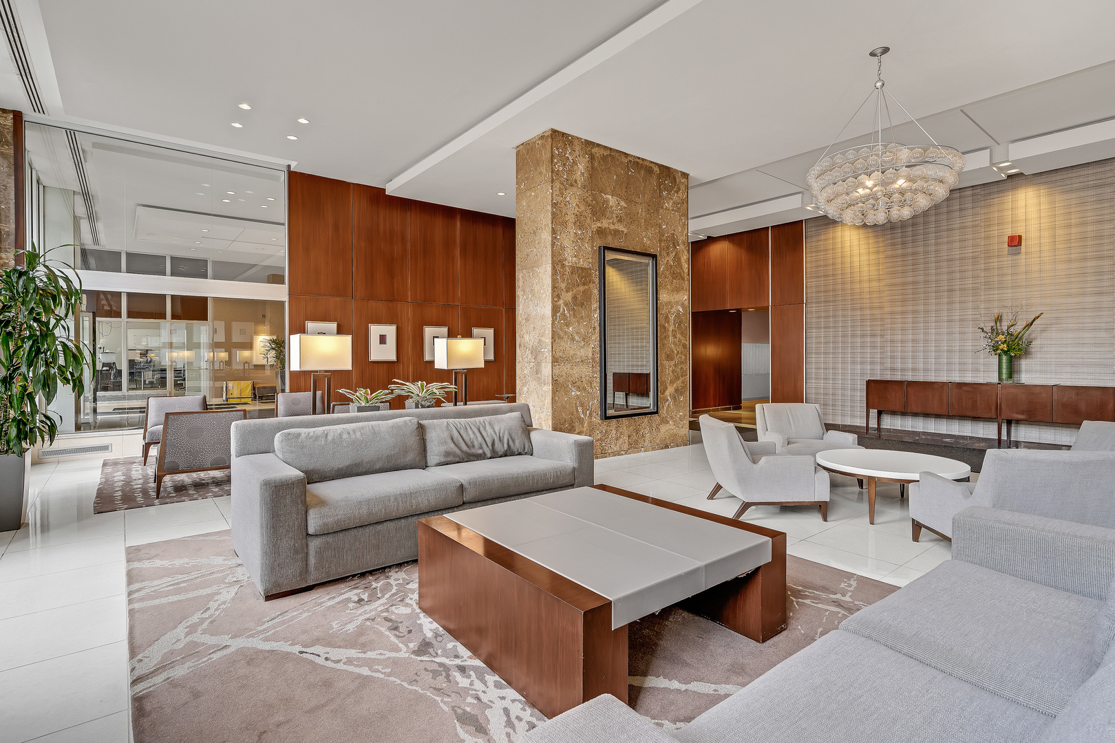 655 West Irving Park Road, Unit 3708 Chicago, IL 60613 - Photo 7 of 55 a living room with patio furniture and a chandelier