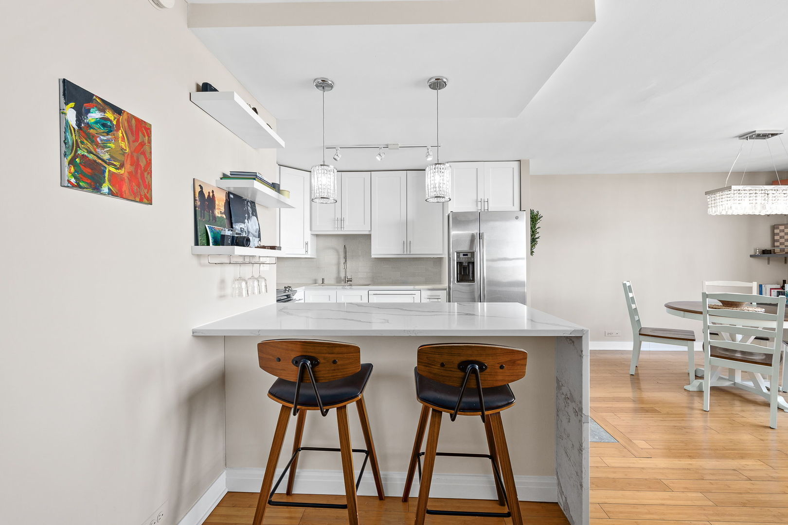 655 West Irving Park Road, Unit 3708 Chicago, IL 60613 - Photo 9 of 55 a kitchen with stainless steel appliances granite countertop a sink a stove a refrigerator and island with wooden floor