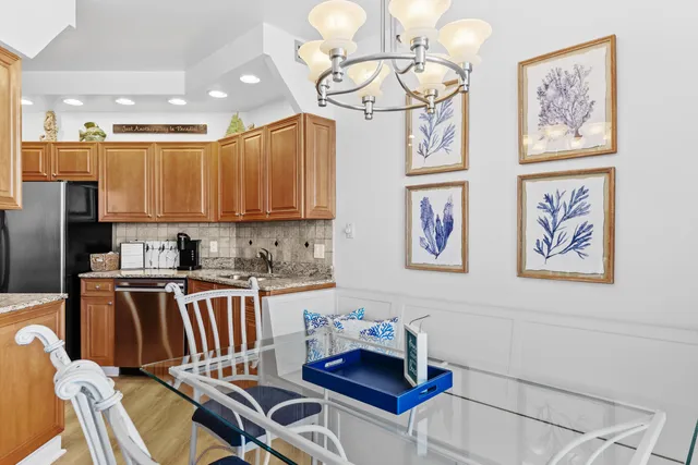 a kitchen with stainless steel appliances granite countertop a refrigerator and a stove top oven