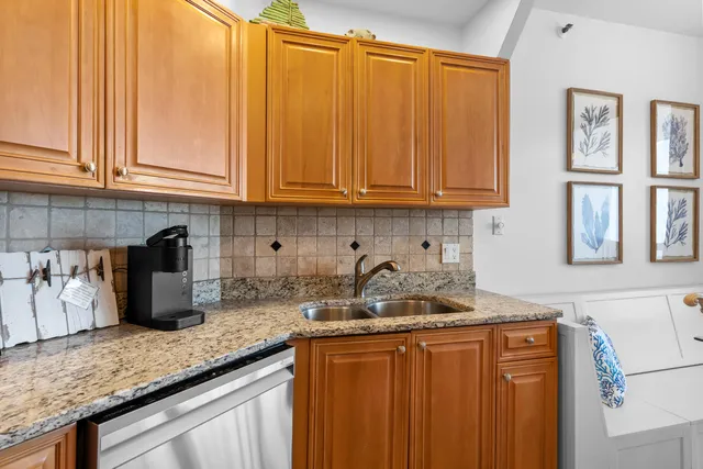 a kitchen with stainless steel appliances granite countertop a refrigerator stove and sink