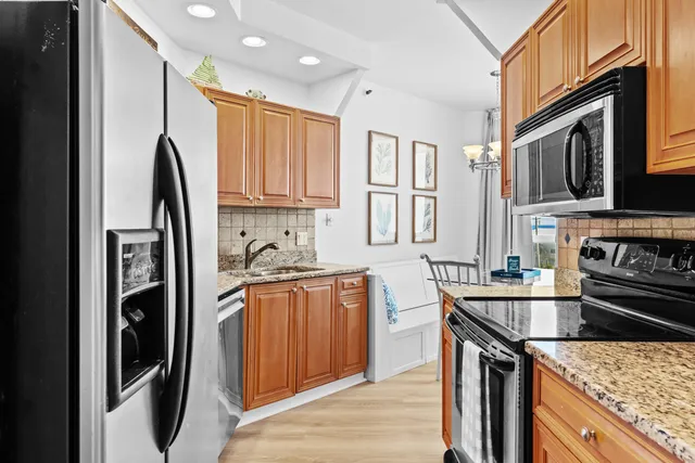 a bedroom with a large bed and a flat tv screen on dresser