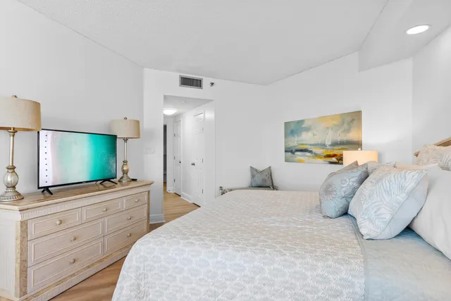 a bedroom with a large bed and a large window