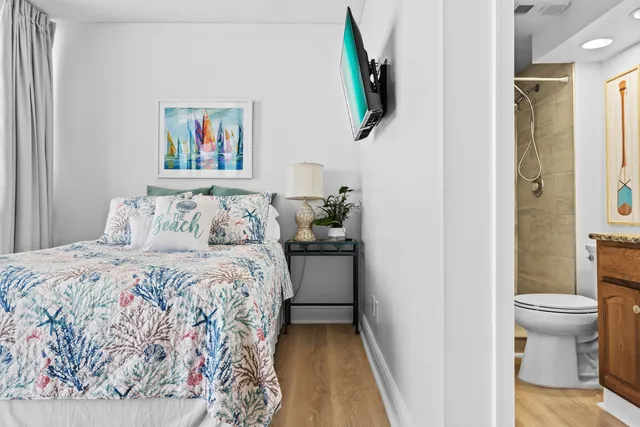 a bathroom with a granite countertop sink toilet and a mirror