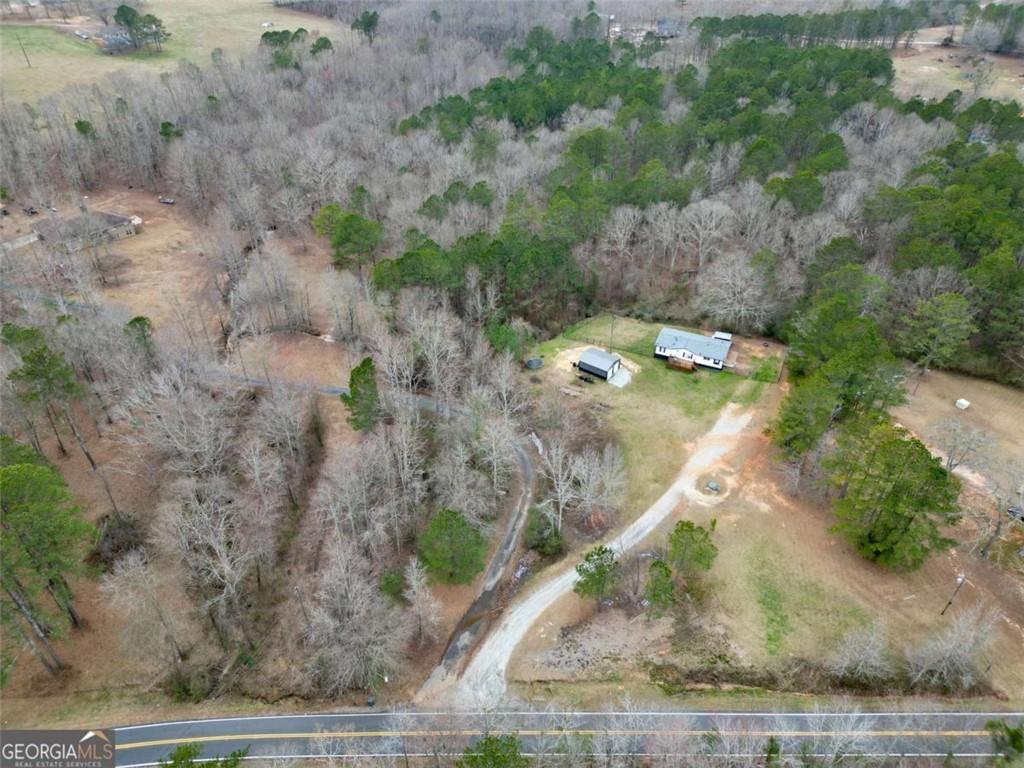 926 Silver Dollar Road Milner, GA 30257 - Photo 4 of 15 a view of a dry yard with wooden fence