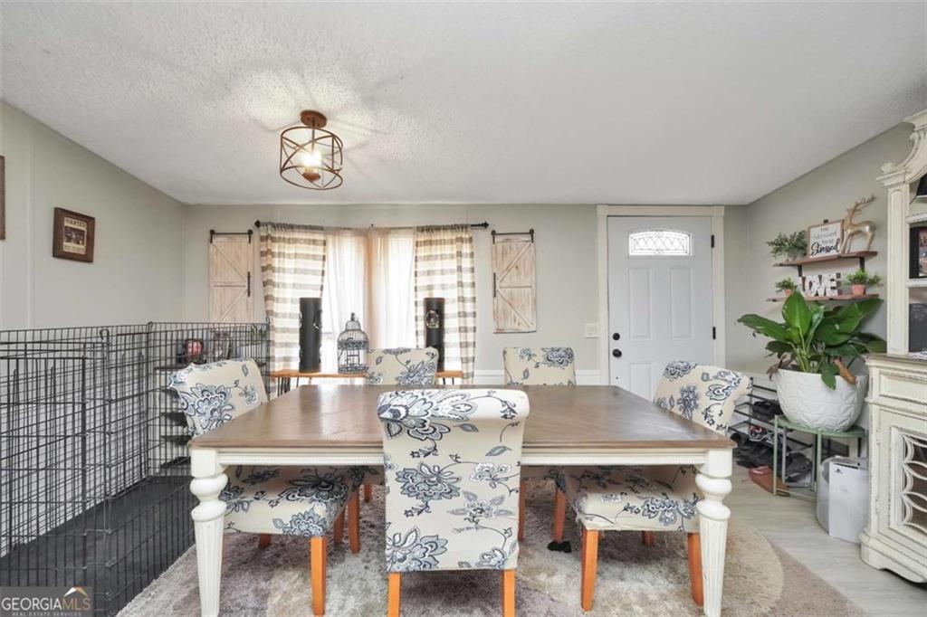 926 Silver Dollar Road Milner, GA 30257 - Photo 5 of 15 a view of a dining room with furniture window and wooden floor