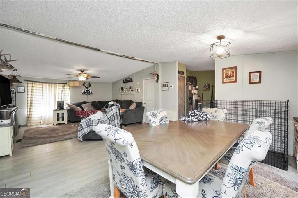 926 Silver Dollar Road Milner, GA 30257 - Photo 8 of 15 a living room with furniture and a chandelier