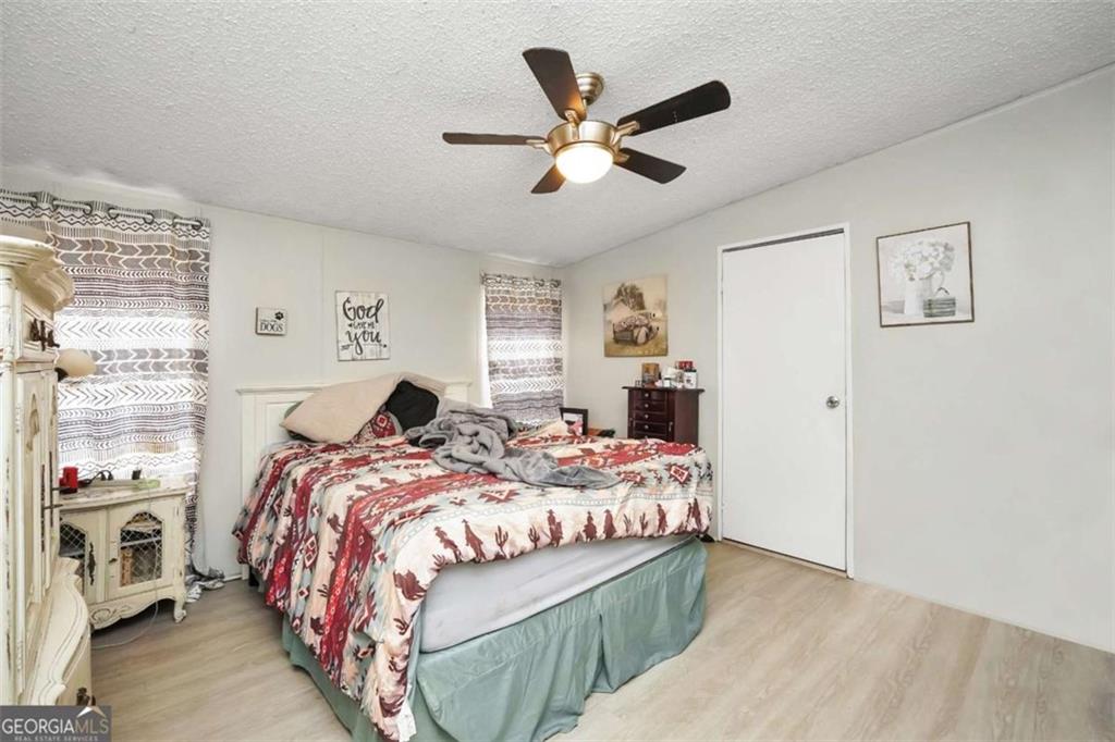 926 Silver Dollar Road Milner, GA 30257 - Photo 10 of 15 a bedroom with a bed and window