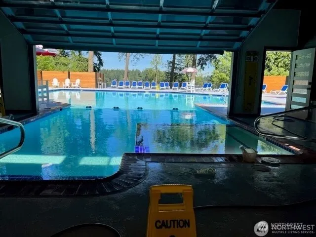 a room with a mini refrigerator a table and chairs