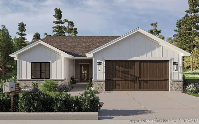 a view of a house with a yard and potted plants