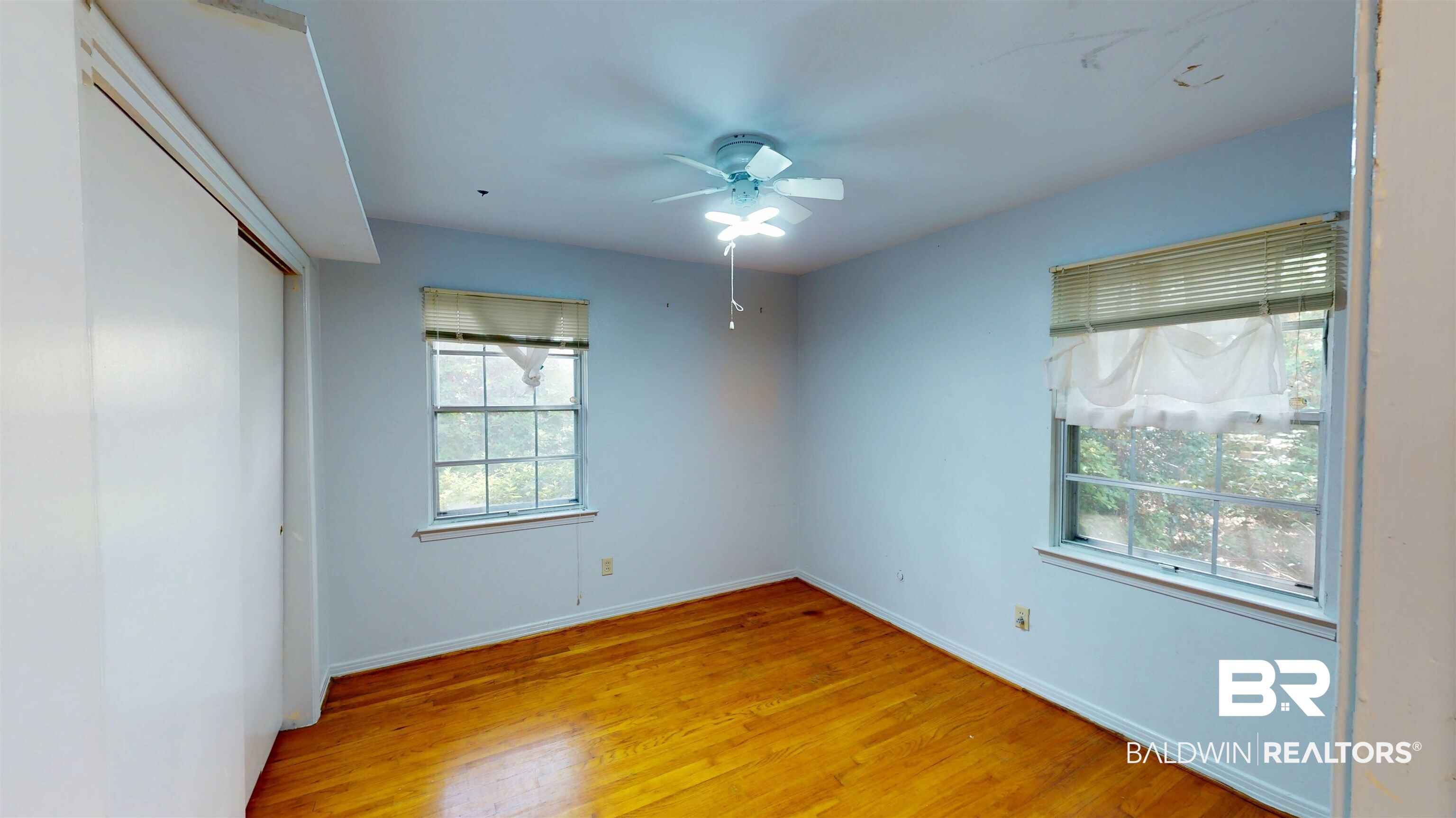 1075 Zurich Street Mobile, AL 36608 - Photo 23 of 35 Unfurnished bedroom featuring a closet, light wood-type flooring, and a ceiling fan