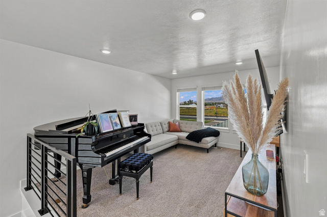 355 West 3085 South Logan, UT 84321 - Photo 19 of 40 Recessed lighting, large windows, wall-to-wall carpeting, and metal railing