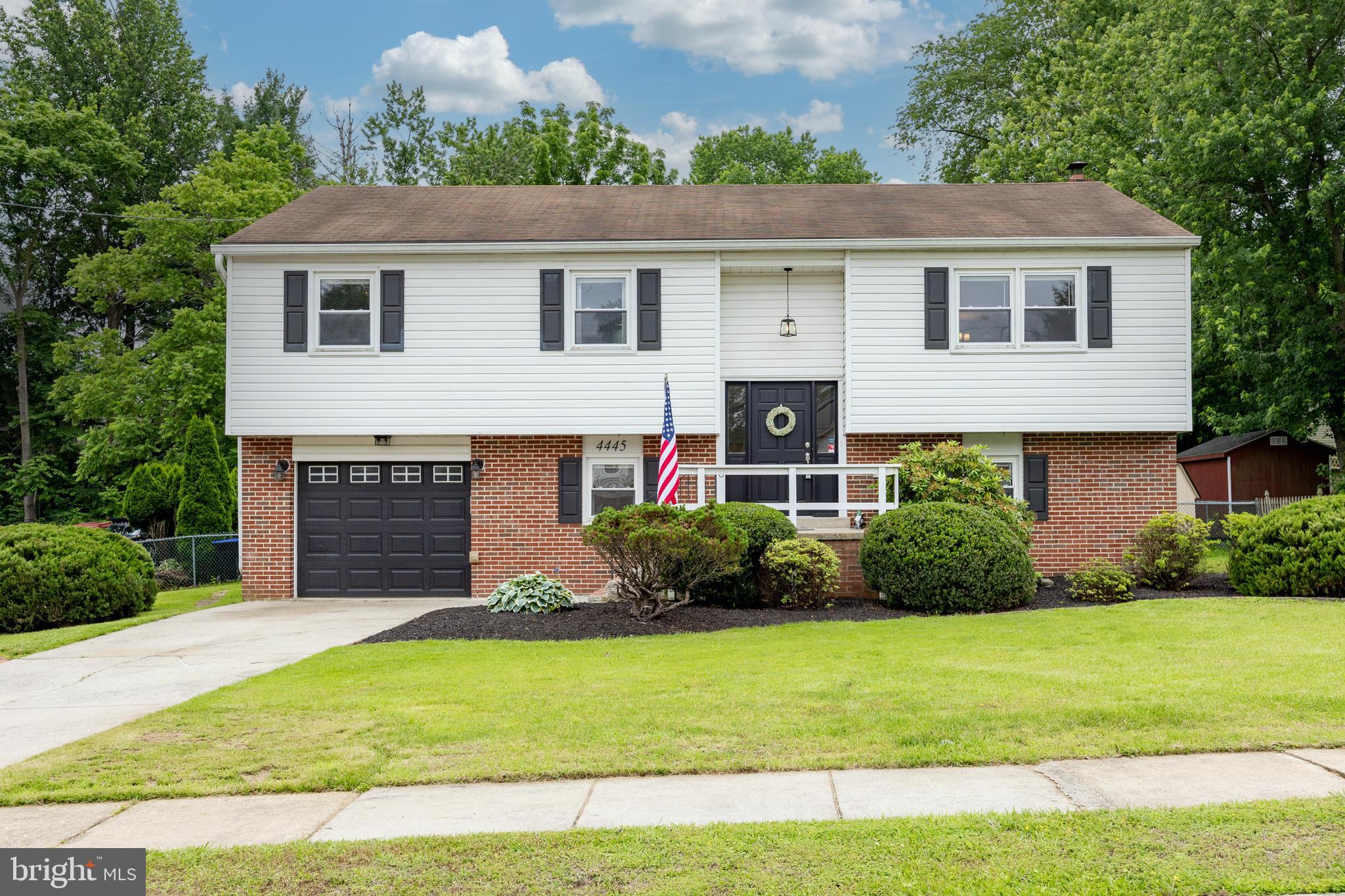 4445 Bethel Road Upper Chichester, PA 19061 - Photo 1 of 41 a front view of a house with a yard and garage