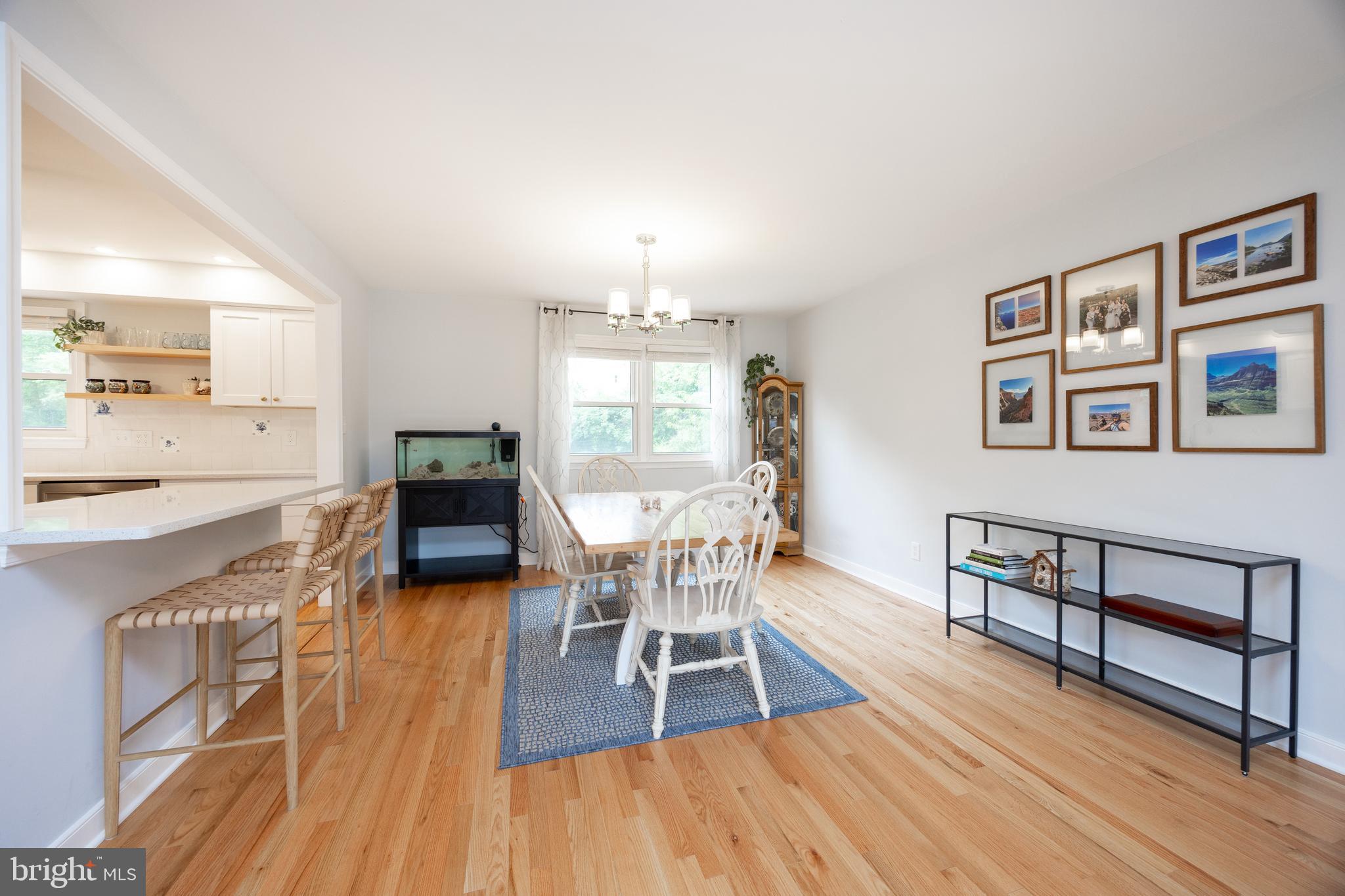 4445 Bethel Road Upper Chichester, PA 19061 - Photo 13 of 41 a dining room with furniture a chandelier and wooden floor