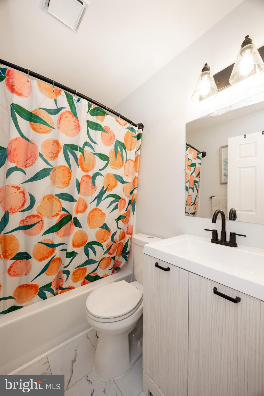 4445 Bethel Road Upper Chichester, PA 19061 - Photo 19 of 41 a bathroom with a sink a toilet and shower curtain