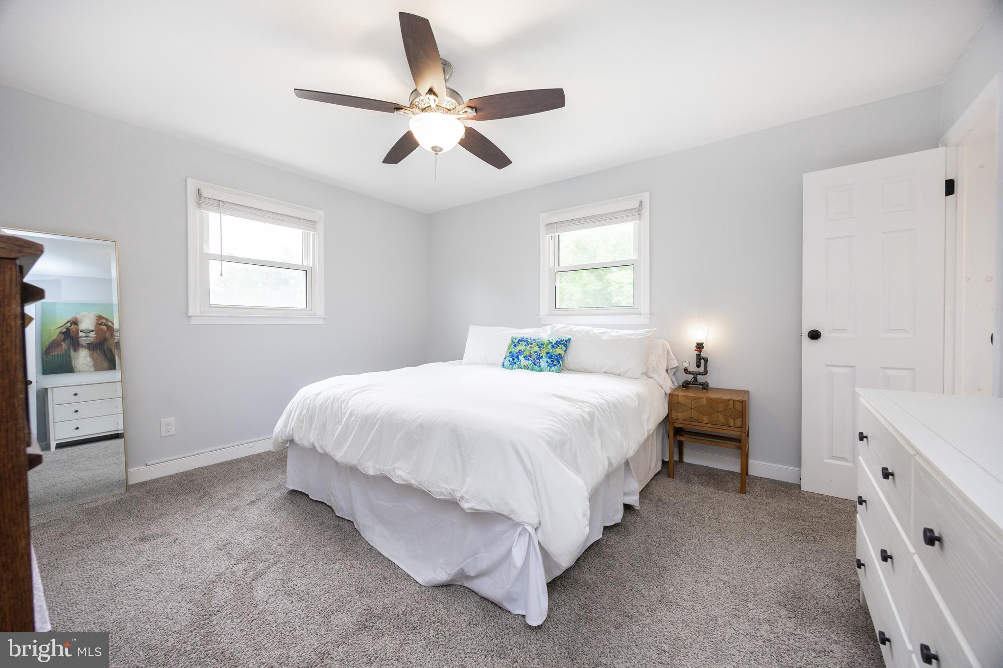 4445 Bethel Road Upper Chichester, PA 19061 - Photo 20 of 41 a spacious bedroom with a bed and a chandelier
