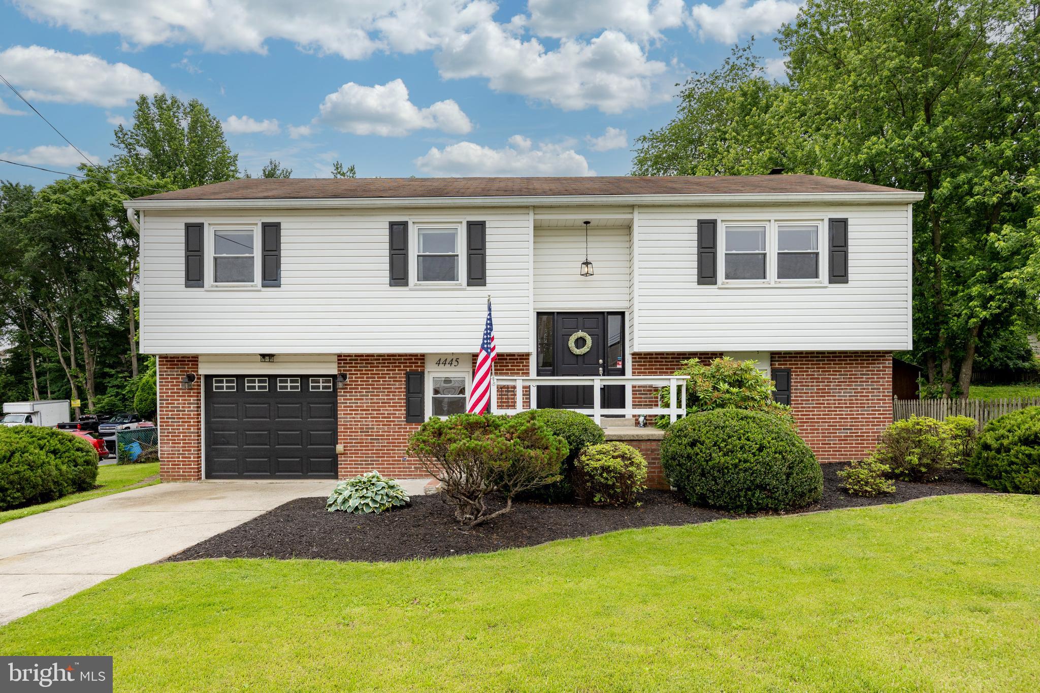 4445 Bethel Road Upper Chichester, PA 19061 - Photo 2 of 41 a front view of a house with a yard and garage