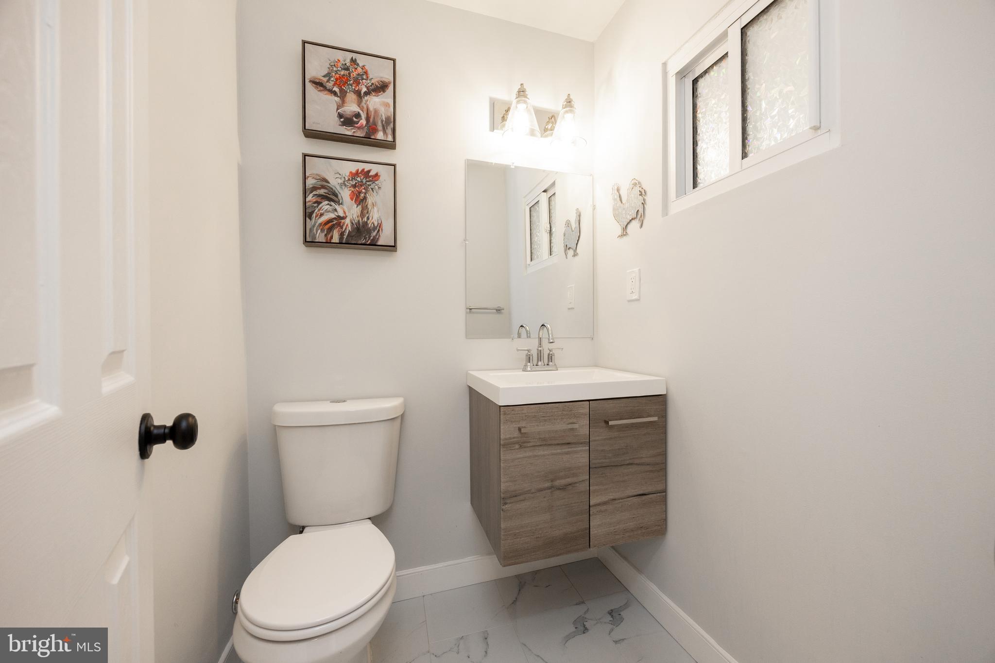 4445 Bethel Road Upper Chichester, PA 19061 - Photo 35 of 41 a bathroom with a toilet a sink and mirror