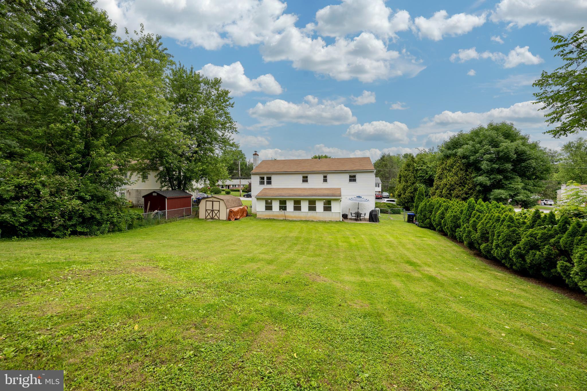 4445 Bethel Road Upper Chichester, PA 19061 - Photo 7 of 41 a view of a house with a big yard and large trees