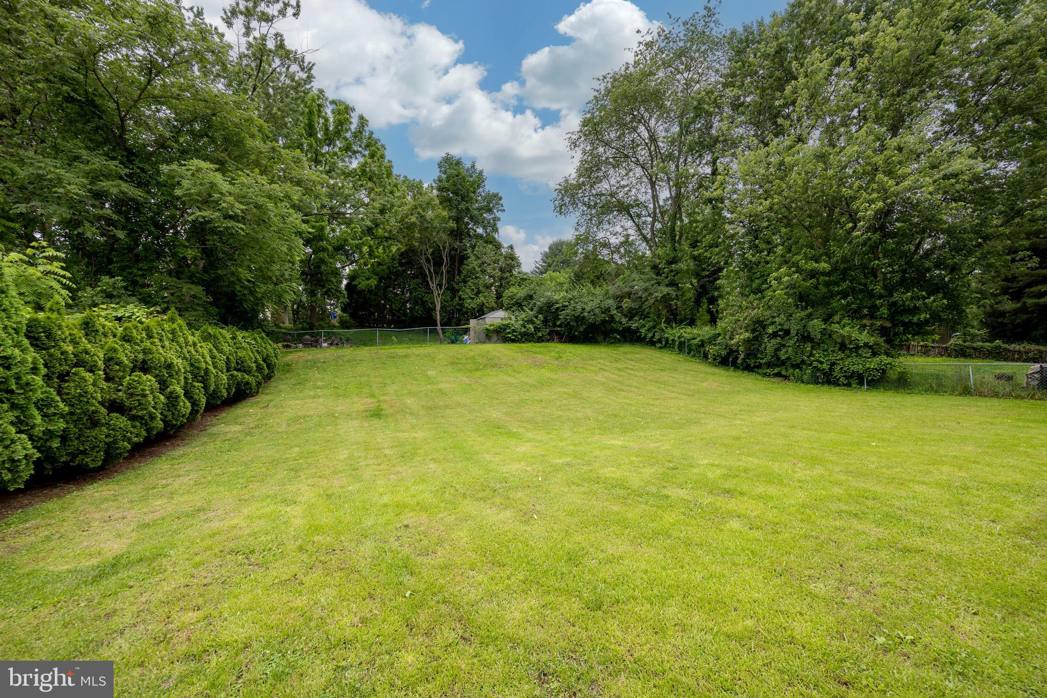 4445 Bethel Road Upper Chichester, PA 19061 - Photo 8 of 41 a view of a big yard with an trees