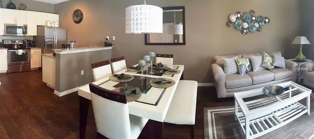 a living room with furniture a window and wooden floor