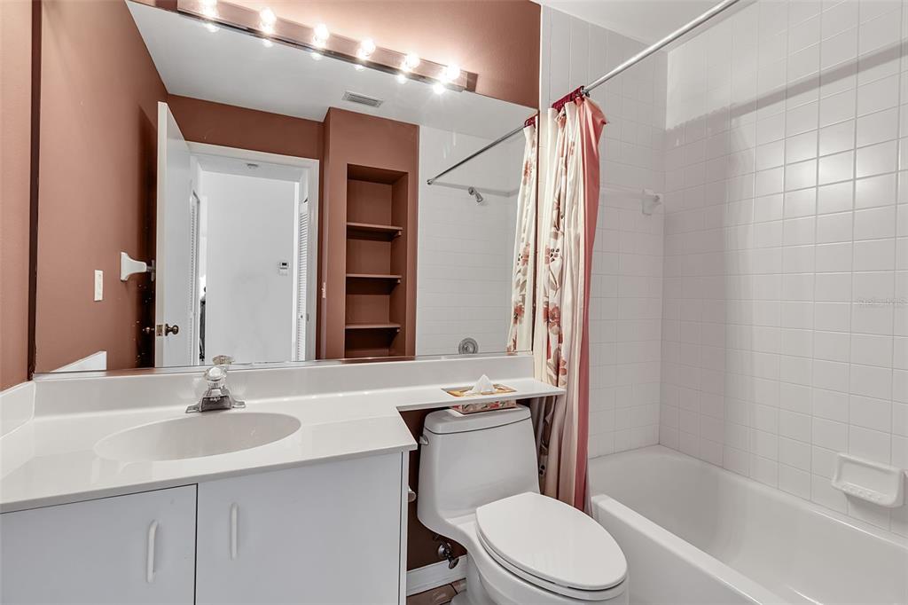 4115 Putter Place, Unit 4115 Bradenton, FL 34203 - Photo 31 of 65 a bathroom with a sink a toilet a mirror and shower