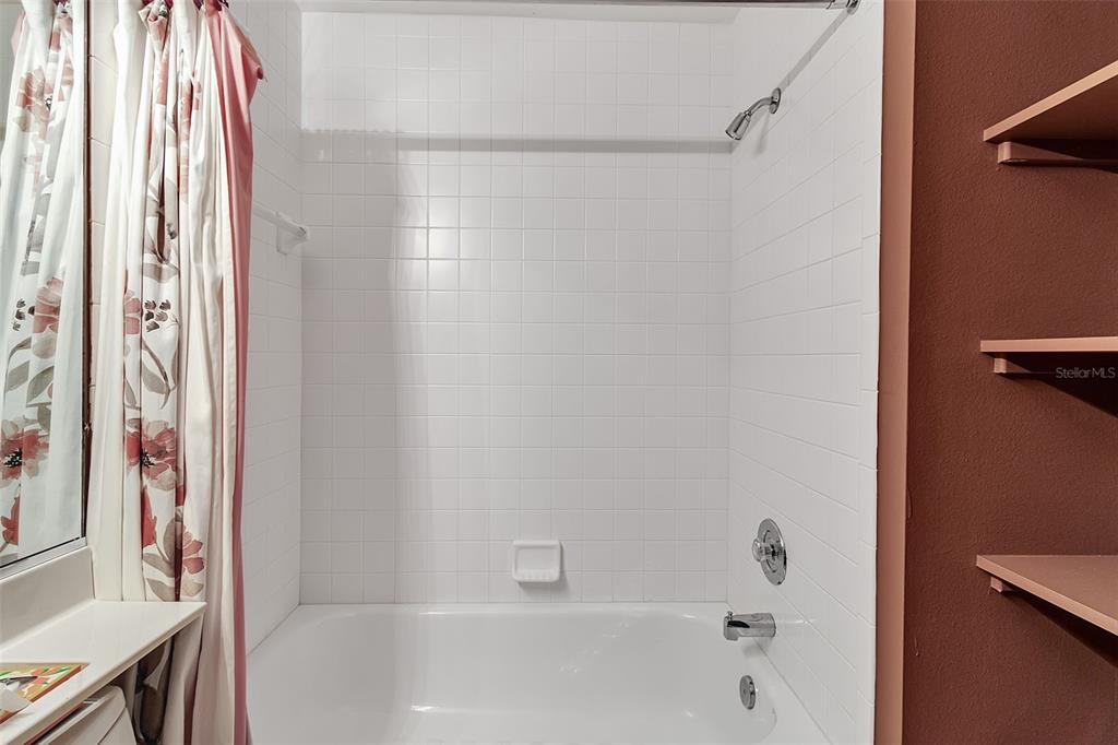 4115 Putter Place, Unit 4115 Bradenton, FL 34203 - Photo 33 of 65 a bathroom with a bathtub and a shower