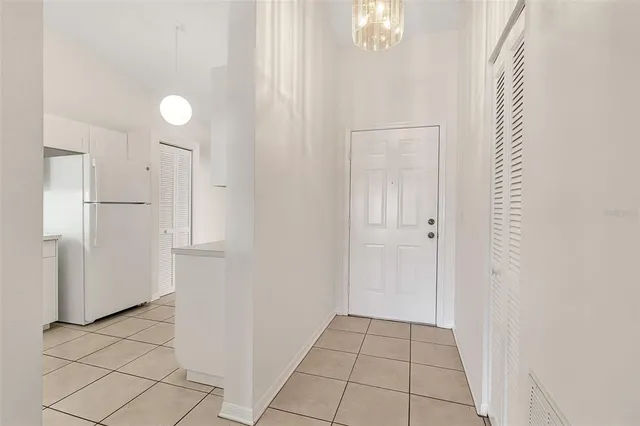 a view of a kitchen with white cabinets