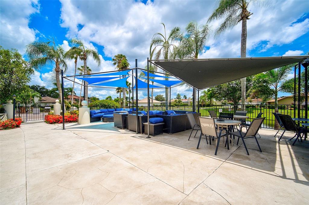 4115 Putter Place, Unit 4115 Bradenton, FL 34203 - Photo 50 of 65 a view of a patio with a table and chairs under an umbrella