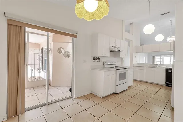 a kitchen with cabinets and chairs