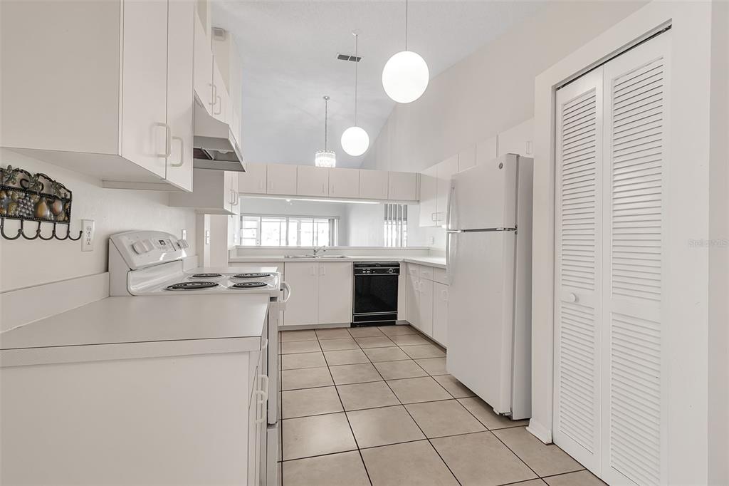 4115 Putter Place, Unit 4115 Bradenton, FL 34203 - Photo 6 of 65 a kitchen with a sink a stove cabinets and refrigerator