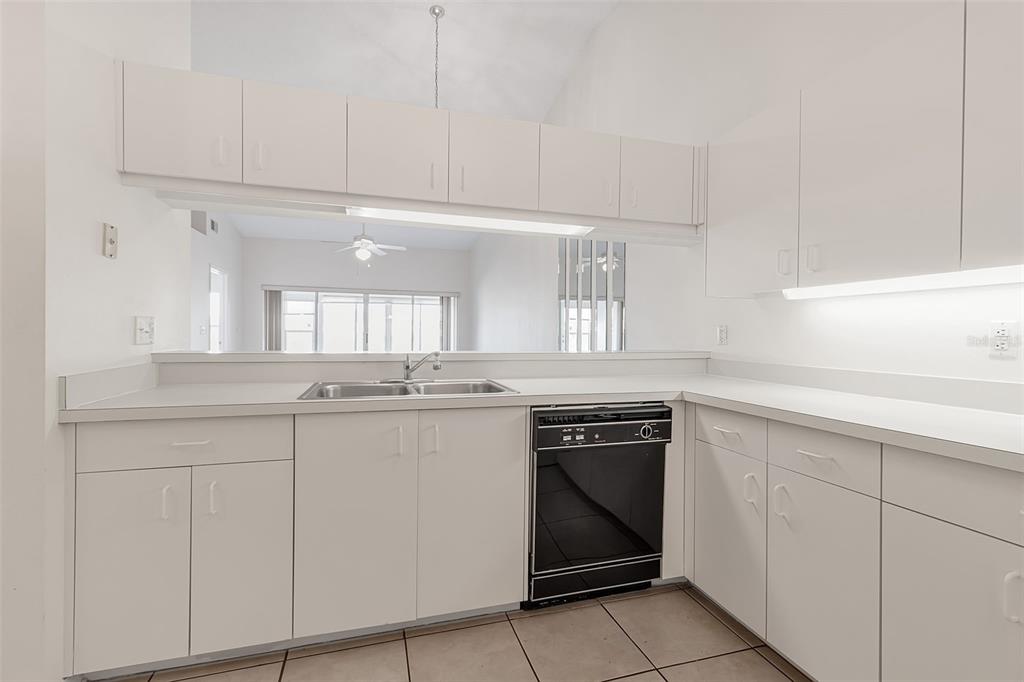 4115 Putter Place, Unit 4115 Bradenton, FL 34203 - Photo 9 of 65 a kitchen with cabinets and appliances