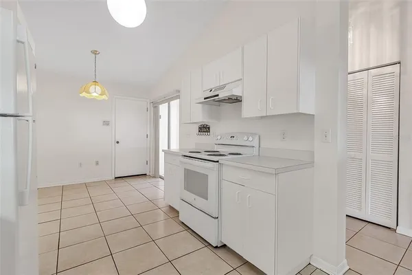 a kitchen with cabinets and appliances
