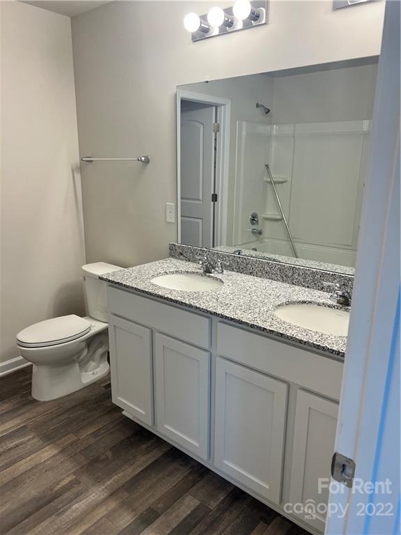 4852 Stone Drive, Unit 127 Conover, NC 28613 - Photo 20 of 34 a bathroom with a granite countertop sink a toilet and a mirror
