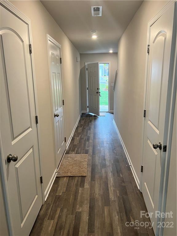 4852 Stone Drive, Unit 127 Conover, NC 28613 - Photo 3 of 34 a view of a hallway with wooden floor and staircase