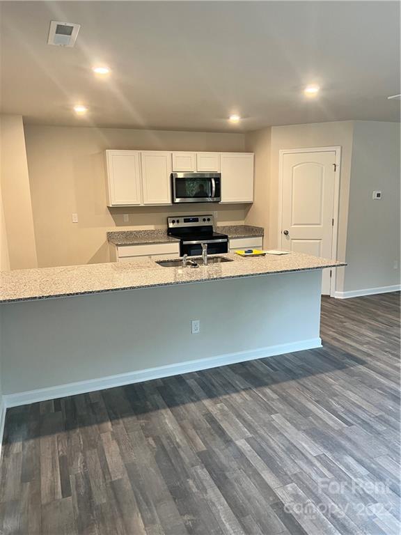 4852 Stone Drive, Unit 127 Conover, NC 28613 - Photo 8 of 34 a view of kitchen with wooden floor and electronic appliances