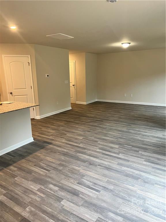 4852 Stone Drive, Unit 127 Conover, NC 28613 - Photo 10 of 34 a view of an empty room with wooden floor and a window