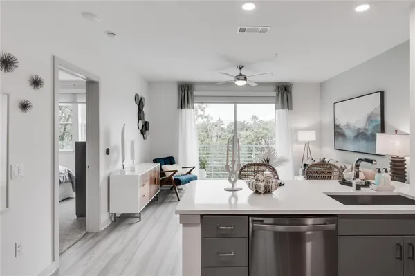a kitchen with sink refrigerator and large window