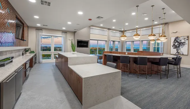 a large dining hall with stainless steel appliances granite countertop lots of counter top space