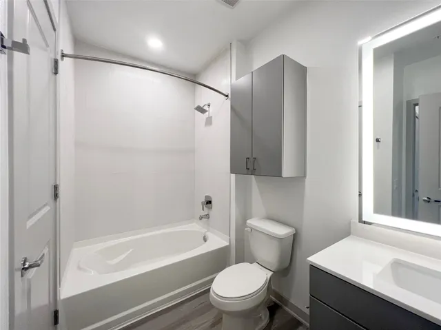 a bathroom with a sink toilet and shower