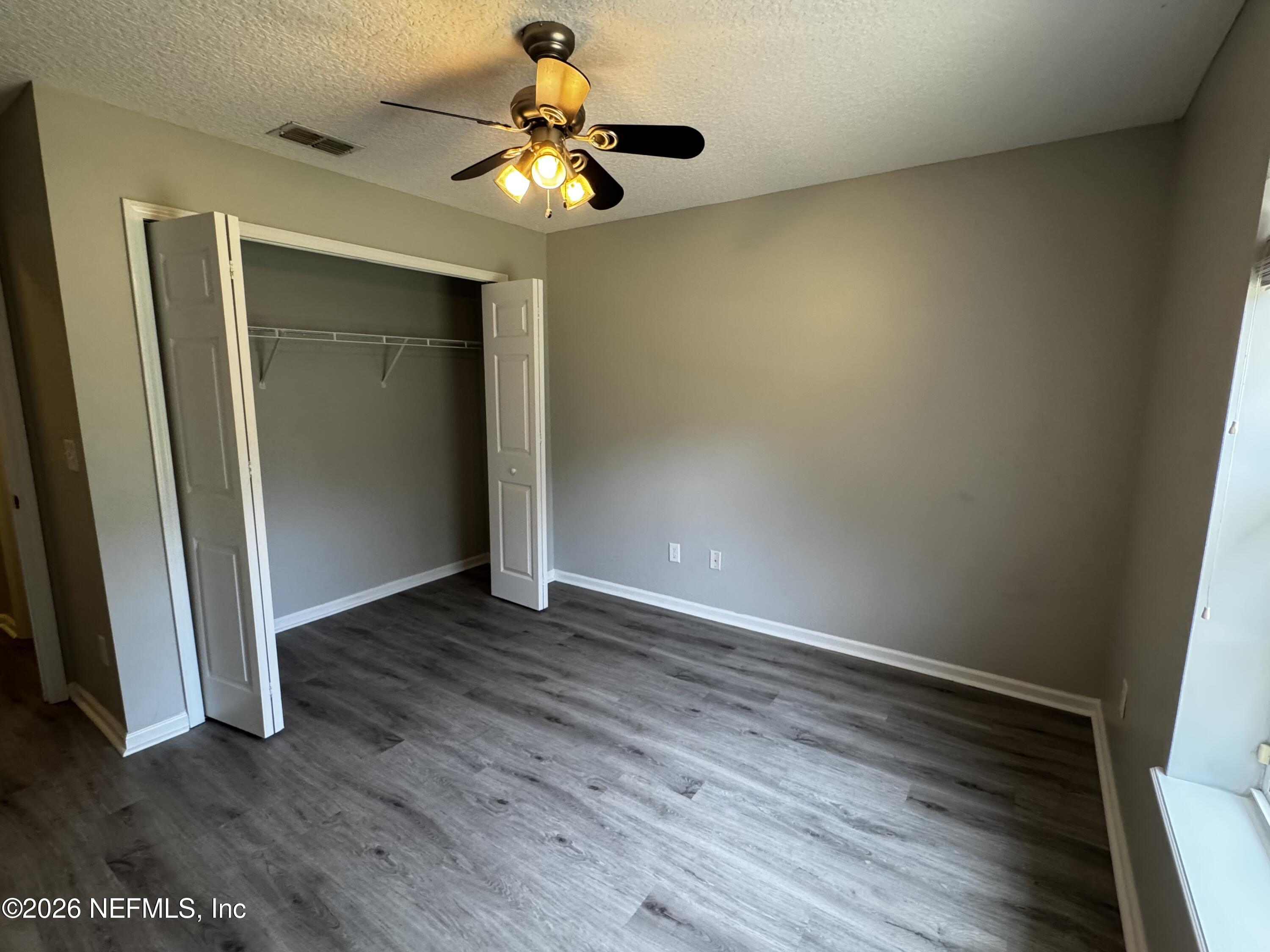 16255 Shellcracker Road Jacksonville, FL 32226 - Photo 22 of 40 an empty room with wooden floor and fan