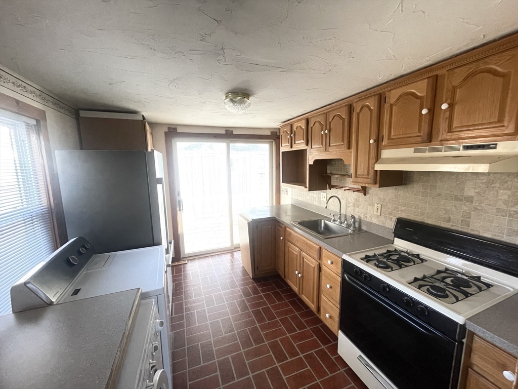 20 Postscript Lane Scituate, MA 02050 - Photo 16 of 19 a kitchen with stainless steel appliances granite countertop a stove a sink and a refrigerator