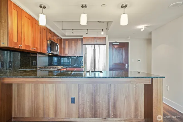a kitchen with stainless steel appliances granite countertop a sink and cabinets