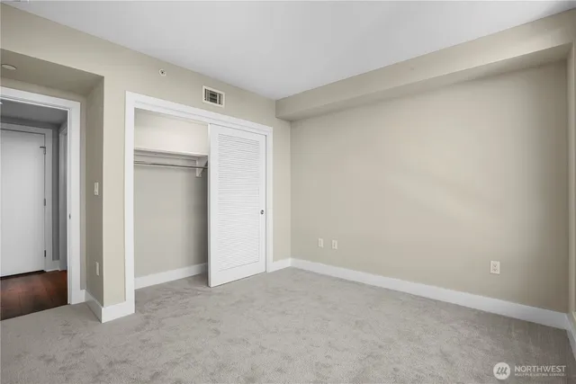 a view of an empty room and closet area