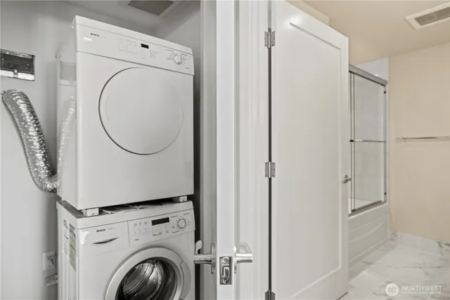 a close view of a utility room with dryer and washer