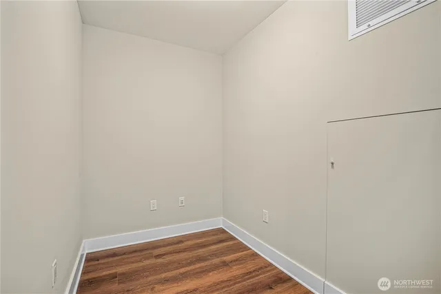 a view of a room with wooden floor