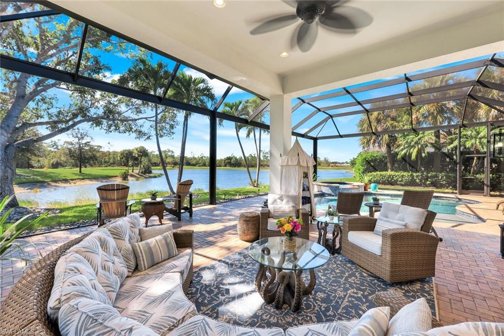 5092 Cerromar Drive Naples, FL 34112 - Photo 11 of 47 a living room with patio furniture and a floor to ceiling window