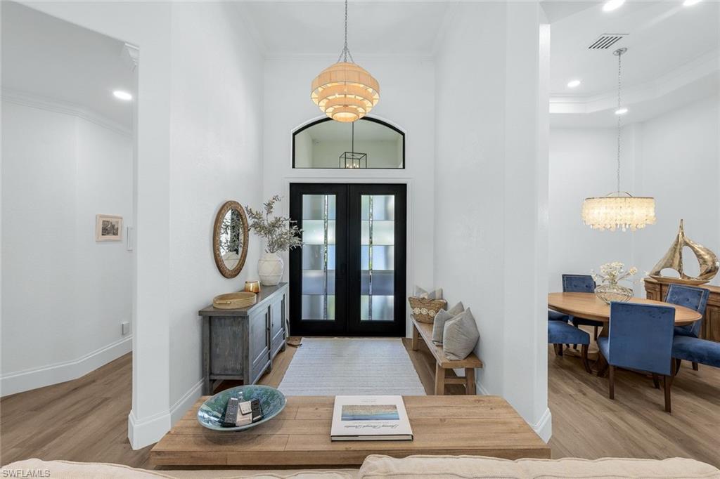 5092 Cerromar Drive Naples, FL 34112 - Photo 13 of 47 a living room with furniture a clock and a rug